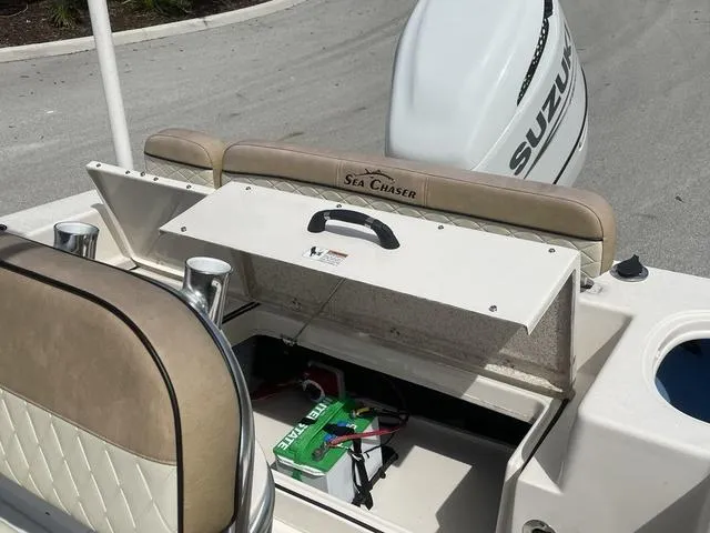 Slide: The Image of 2023 Sea Chaser 22 HFC boat with open storage compartments and seating. - 20