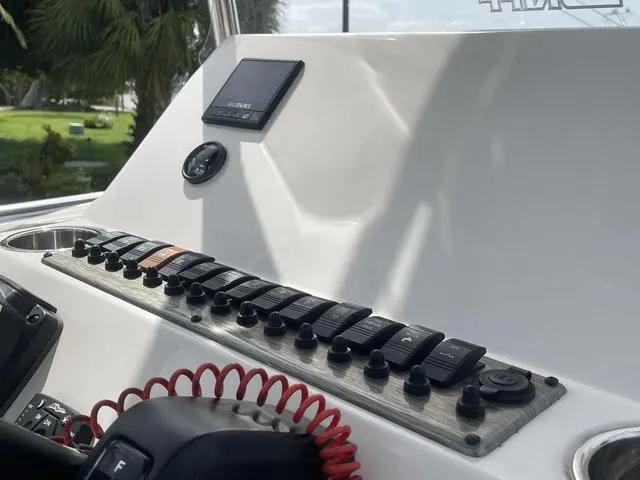 Slide: The Image of 2023 Sea Chaser 22 HFC boat with open storage compartment and Suzuki outboard motor. - 21