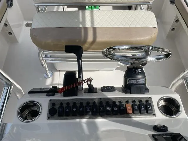 Slide: The Image of Control panel of a 2023 Sea Chaser 22 HFC boat with switches and gauges. - 22