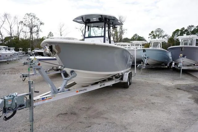 Slide: The Image of 2024 Sea Pro 242 DLX boat on a trailer in a boatyard. - 18