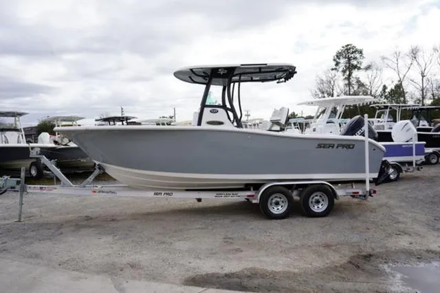 Slide: The Image of 2024 Sea Pro 242 DLX boat on a trailer, side view. - 21