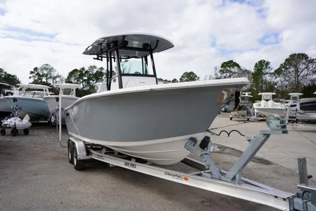 Slide: The Image of 2024 Sea Pro 242 DLX boat on trailer in marina. - 23