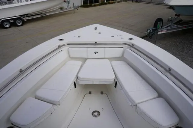 Slide: The Image of 2024 Sea Pro 242 DLX boat bow seating area with white cushions. - 26