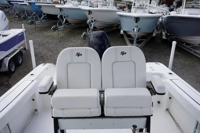 Slide: The Image of 2024 Sea Pro 242 DLX boat seats, white leather, marina background. - 29