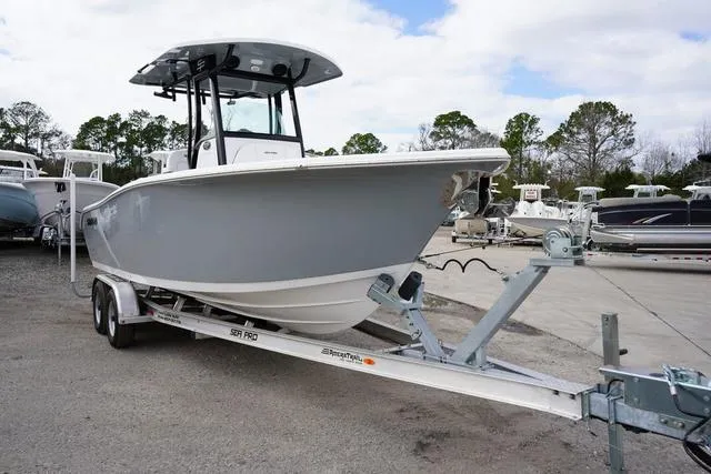 Slide: The Image of 2024 Sea Pro 242 DLX boat on trailer in marina. - 4