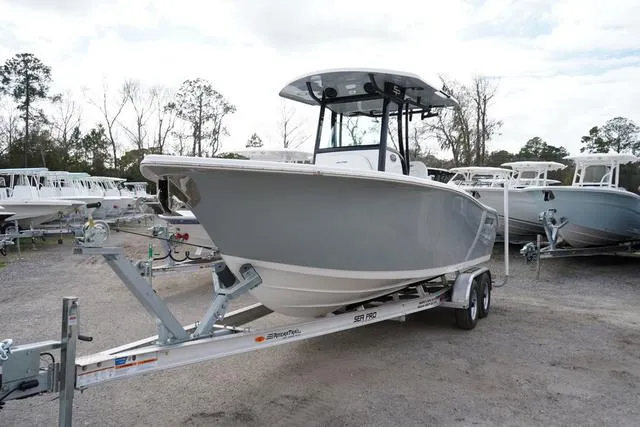 Slide: The Image of 2024 Sea Pro 242 DLX boat on a trailer in a marina. - 7