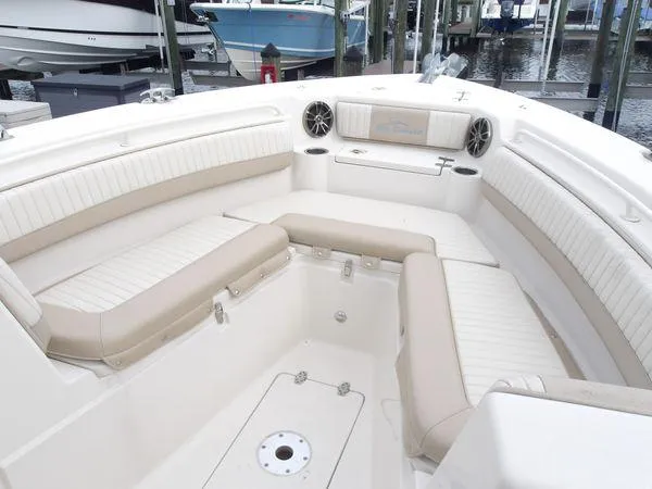 Slide: The Image of 2019 Sea Chaser 27 HFC boat interior with beige seating and cup holders. - 10
