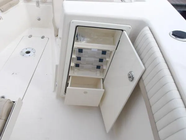 Slide: The Image of 2019 Sea Chaser 27 HFC boat interior with open storage compartment and seating. - 15
