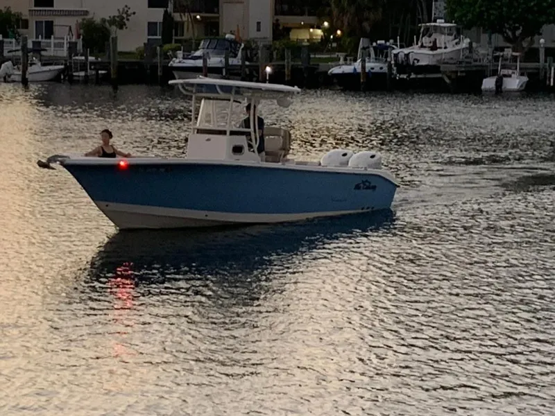 Slide: The Image of 2019 Sea Chaser 27 HFC boat cruising on calm waters at dusk. - 3