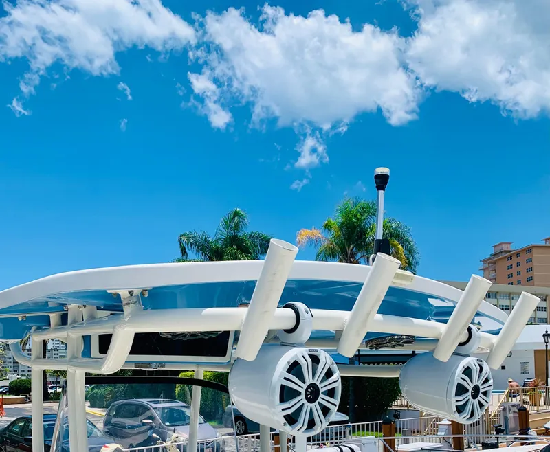 Slide: The Image of 2019 Sea Chaser 27 HFC boat with rod holders and speakers under a clear blue sky. - 5