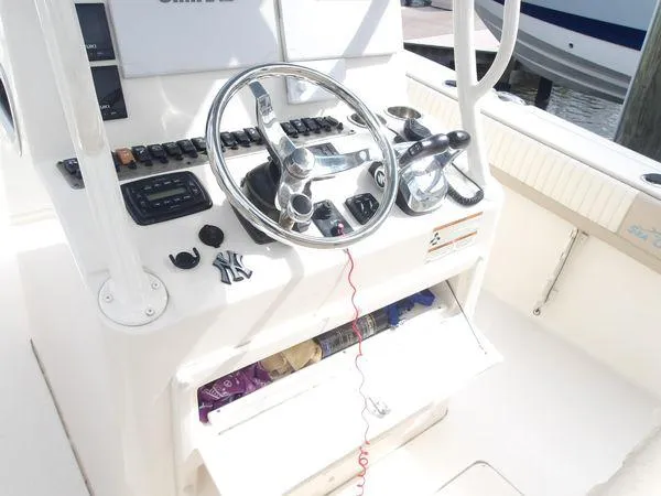 Slide: The Image of 2019 Sea Chaser 27 HFC boat helm with steering wheel and controls. - 6