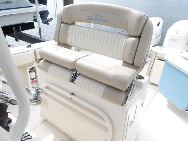 Slide: The Image of 2019 Sea Chaser 27 HFC boat seating, featuring beige and white cushioned seats. - 9