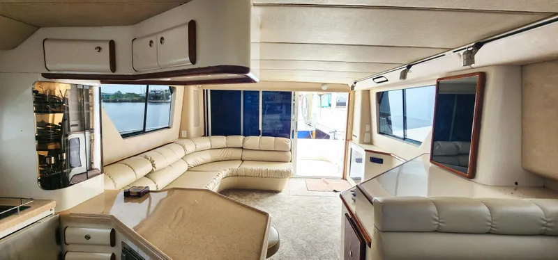 Slide: The Image of Luxurious interior of a 1997 Sea Ray 550 Sedan Bridge yacht with panoramic windows. - 19
