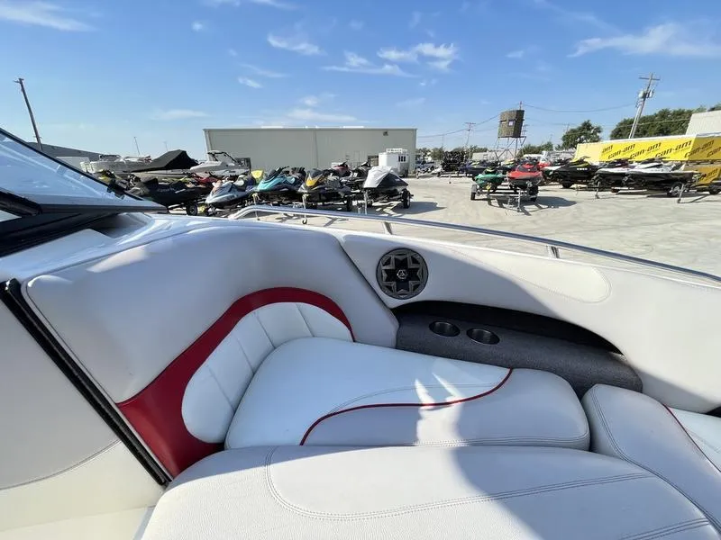 Slide: The Image of Interior of a 2006 Malibu 23 LSV boat with white and red seating. - 12