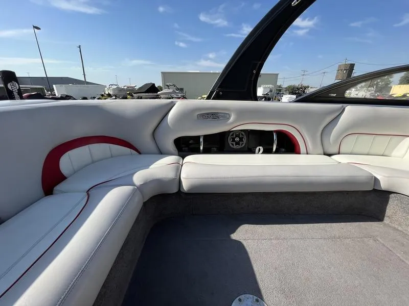 Slide: The Image of Interior of a 2006 Malibu 23 LSV boat with white and red seating. - 13