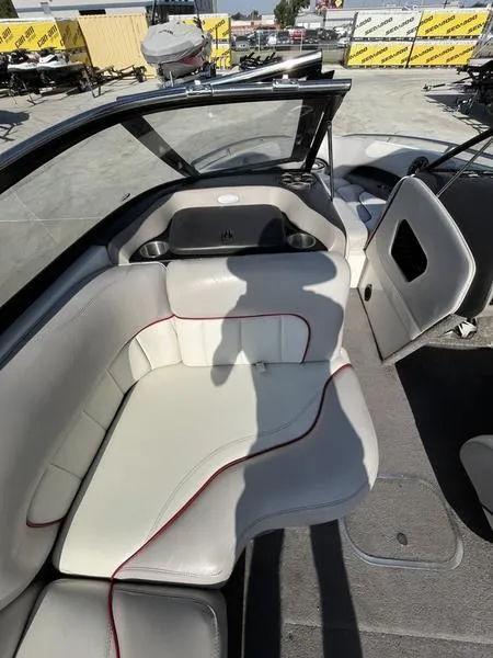 Slide: The Image of 2006 Malibu 23 LSV boat interior with white and red seating. - 5