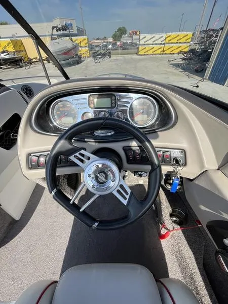 Slide: The Image of 2006 Malibu 23 LSV boat dashboard with steering wheel and control panel. - 8