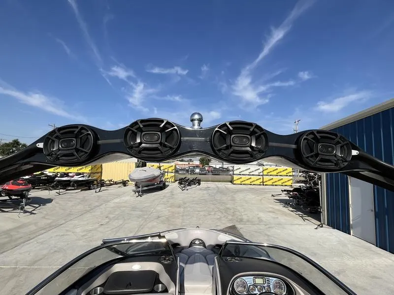 Slide: The Image of 2006 Malibu 23 LSV boat with mounted speakers and dashboard view. - 9