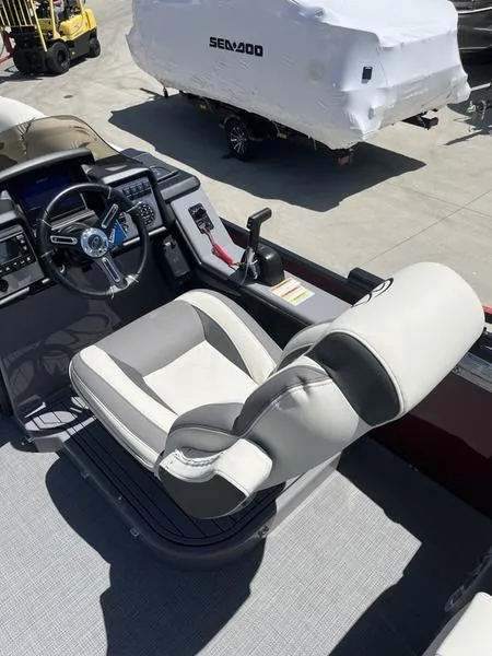 Slide: The Image of 2023 Veranda VP22RFL boat interior with captain's chair and control console. - 11