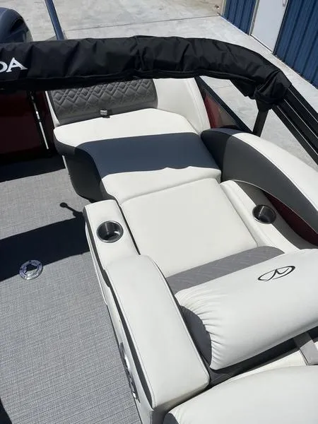 Slide: The Image of 2023 Veranda VP22RFL boat with luxurious white seating and cup holders. - 13