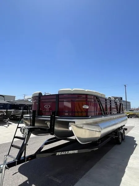 Slide: The Image of 2023 Veranda VP22RFL pontoon boat on trailer under clear blue sky. - 4