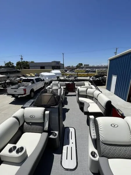 Slide: The Image of 2023 Veranda VP22RFL pontoon boat with luxurious seating at a dealership. - 6