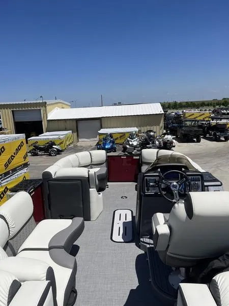 Slide: The Image of 2023 Veranda VP22RFL pontoon boat with white seating and modern dashboard. - 7