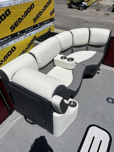 Slide: The Image of 2023 Veranda VP22RFL pontoon boat seating area with cup holders, displayed near Sea-Doo packaging. - 9