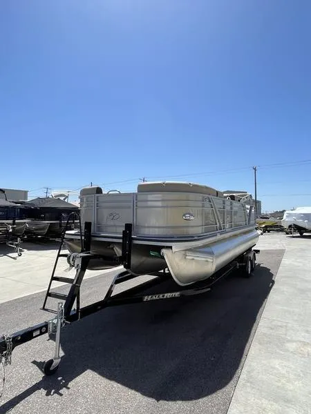 Slide: The Image of 2023 Veranda VP22VLB pontoon boat on trailer under clear blue sky. - 4