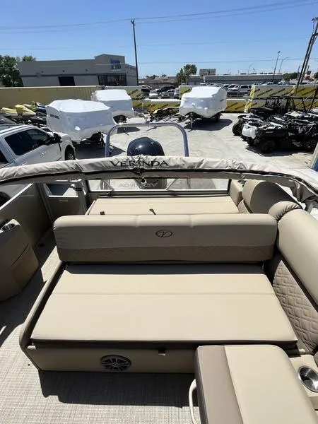Slide: The Image of 2023 Veranda VP22VLB pontoon boat with beige seating and covered storage area. - 9