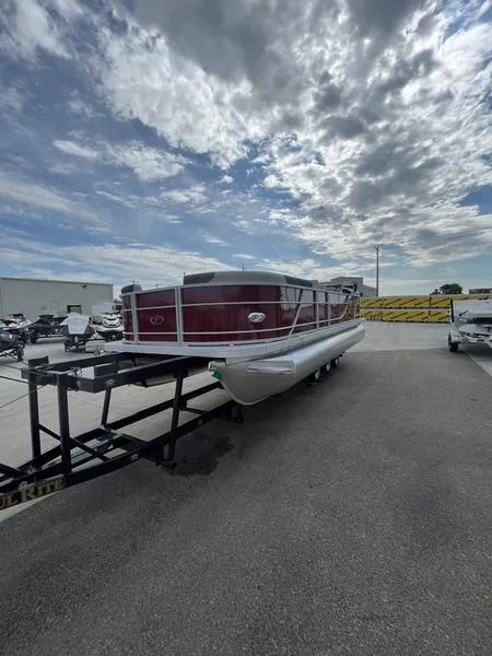 Slide: The Image of 2023 Veranda VR22RC pontoon boat on trailer under cloudy sky. - 2