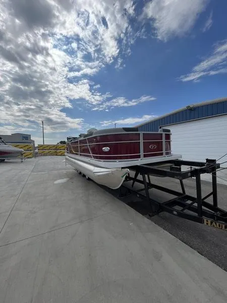 Slide: The Image of 2023 Veranda VR22RC pontoon boat on a trailer under a partly cloudy sky. - 3
