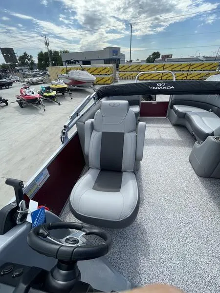 Slide: The Image of 2023 Veranda VR22RC pontoon boat interior with captain's chair and steering wheel. - 6