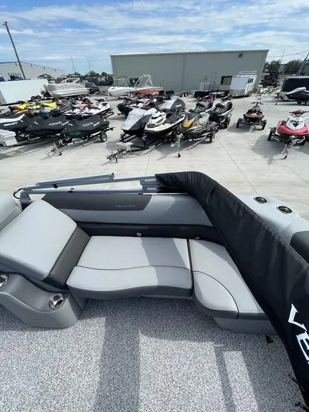 Slide: The Image of 2023 Veranda VR22RC pontoon boat with gray seating, displayed in a marina. - 7