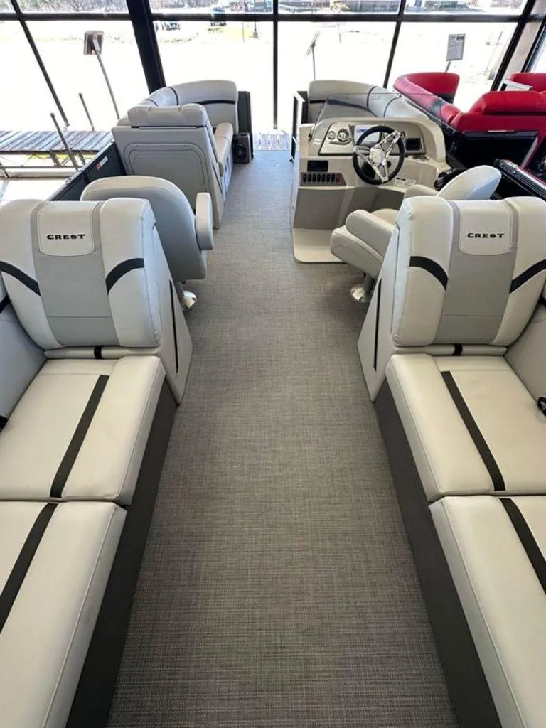 Slide: The Image of 2024 Crest Classic LX 220 SLC CPT boat interior with luxurious seating and modern design. - 11