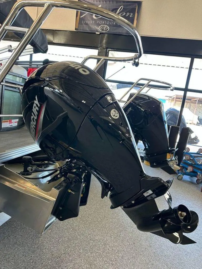 Slide: The Image of 2024 Crest Classic LX 220 SLC CPT with Mercury outboard motor in showroom. - 12