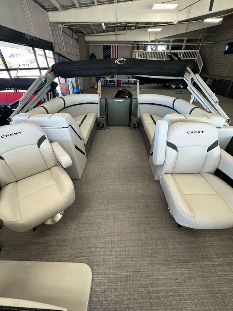 Slide: The Image of 2024 Crest Classic LX 220 SLC CPT pontoon boat interior with plush seating. - 4
