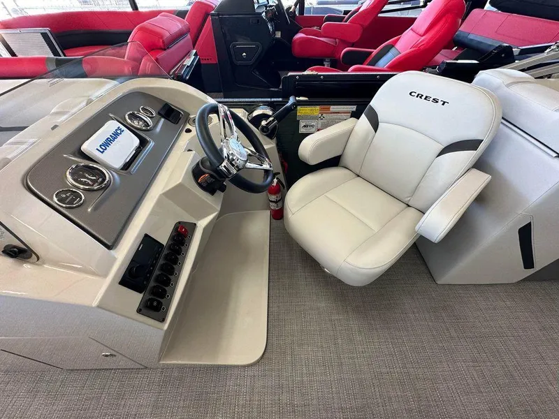 Slide: The Image of 2024 Crest Classic LX 220 SLC CPT boat interior with steering console and seating. - 7