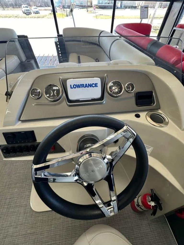 Slide: The Image of 2024 Crest Classic LX 220 SLC CPT boat dashboard with Lowrance display and steering wheel. - 8