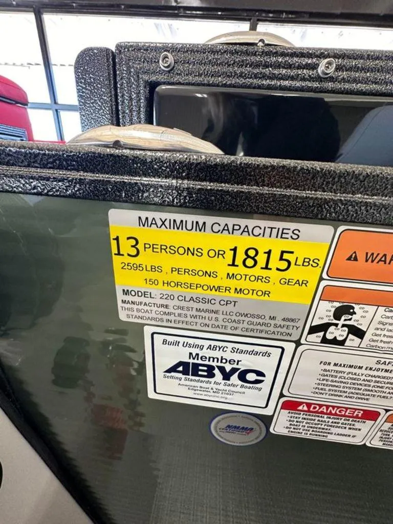 Slide: The Image of 2024 Crest Classic LX 220 SLC CPT capacity label, 13 persons or 1815 lbs, 150 HP motor. - 9