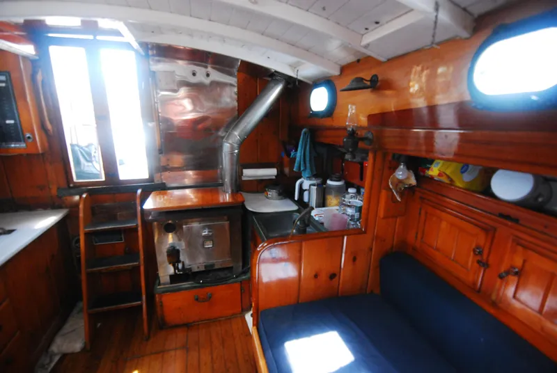 Slide: The Image of Interior of a 1939 Concordia Motorsailer with wooden cabinetry and nautical decor. - 13