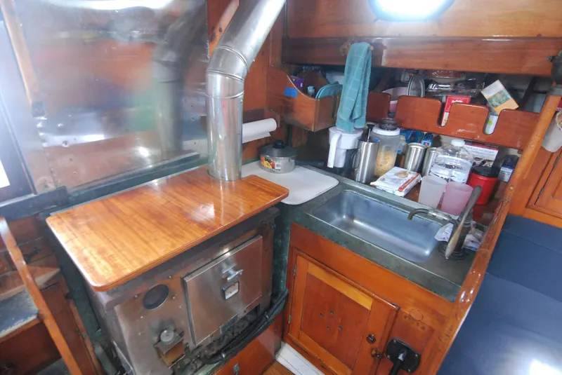 Slide: The Image of Compact kitchen area in a 1939 Concordia Motorsailer, featuring a stove and sink. - 17