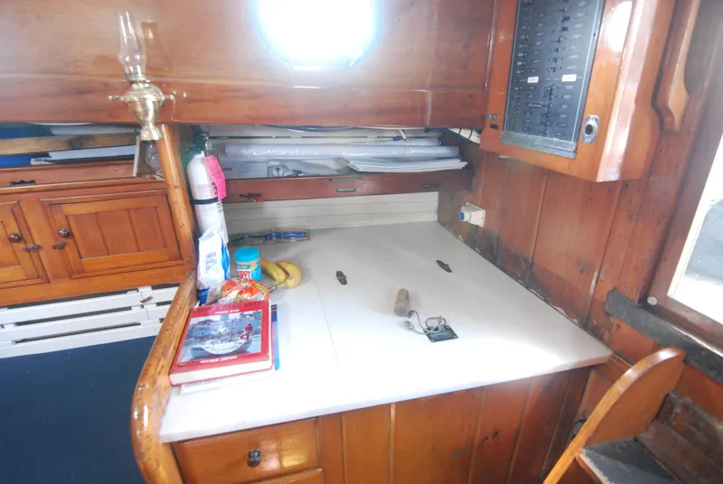 Slide: The Image of 1939 Concordia Motorsailer interior with wooden cabinetry and navigation desk. - 18