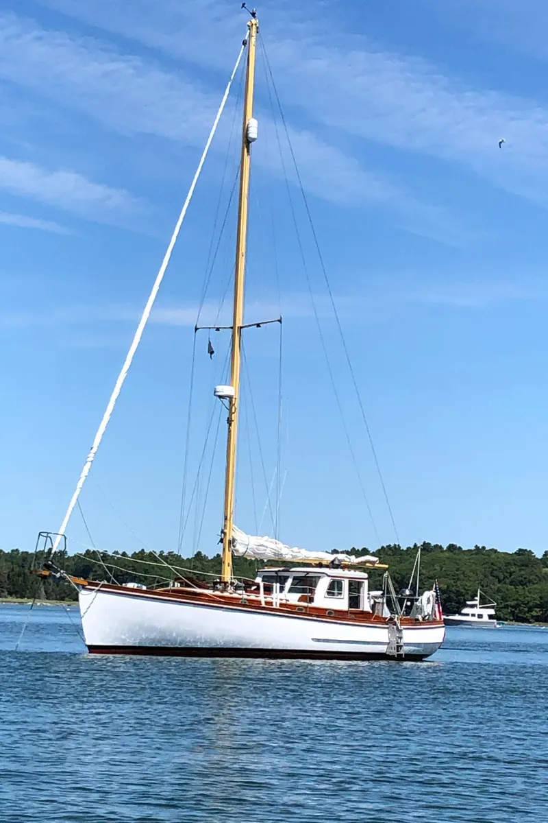 Slide: The Image of Vintage 1939 Concordia Motorsailer on calm water under clear blue sky. - 2