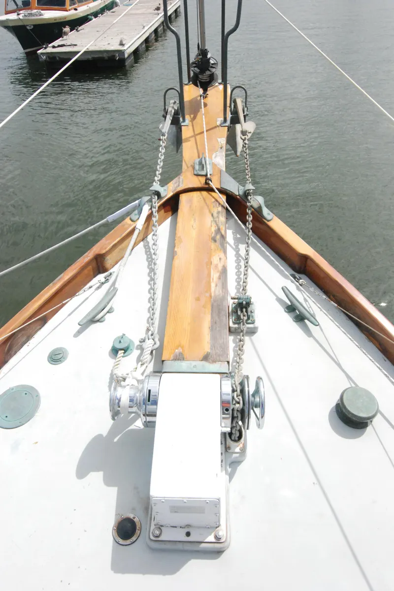 Slide: The Image of Bow of 1939 Concordia Motorsailer at dock, featuring anchor chain and winch. - 6