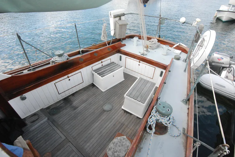 Slide: The Image of 1939 Concordia Motorsailer deck with wooden seating and nautical equipment. - 7