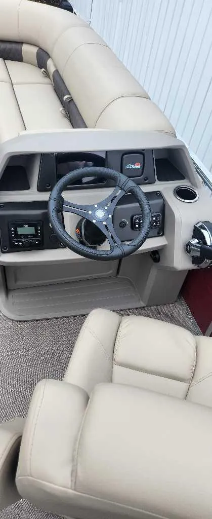 Slide: The Image of 2024 Sun Tracker Party Barge 22 RF XP3 interior with steering wheel and seating. - 11