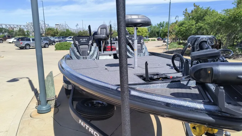 Slide: The Image of 2024 Nitro Z21 XL Pro fishing boat in a parking lot. - 2