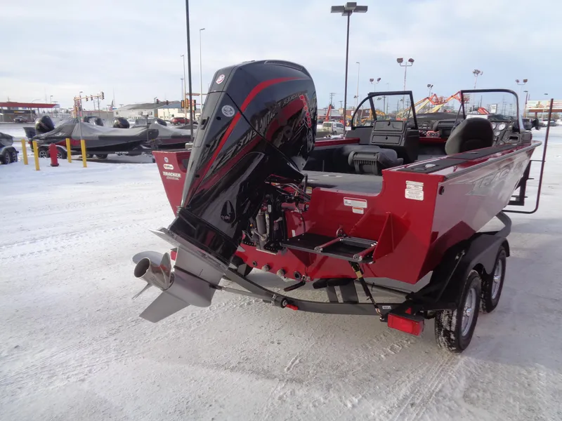 Slide: The Image of 2024 Tracker Targa V-19 WT boat with powerful outboard motor on snowy lot. - 2