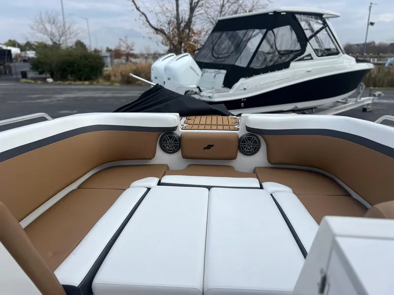 Slide: The Image of 2024 Starcraft SVX 231 OB DH boat in a showroom. - 5